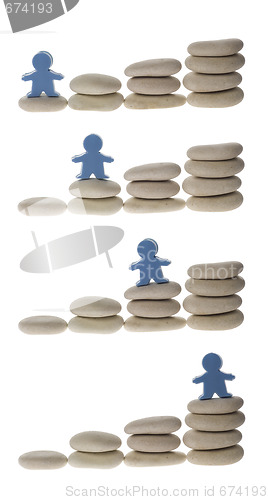 Image of Series of figurine on stack of pebbles