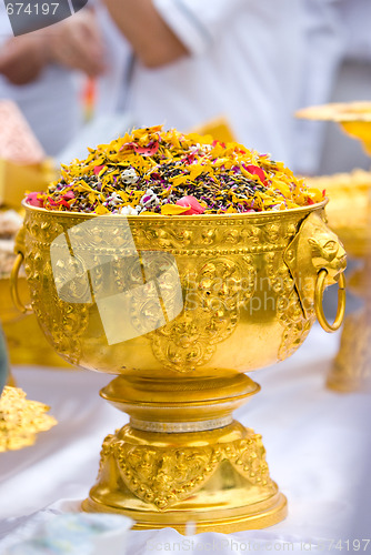 Image of Dried flower petals in a golden bowl