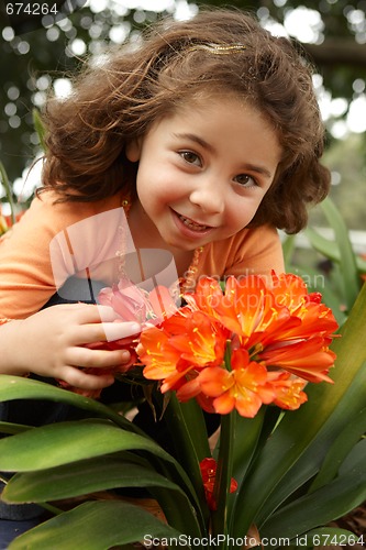 Image of Little girl in a garden of clivia miniata