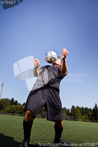 Image of Hispanic soccer or football player with soccer ball