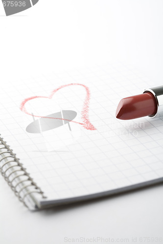 Image of Lipstick and heart on notepad.