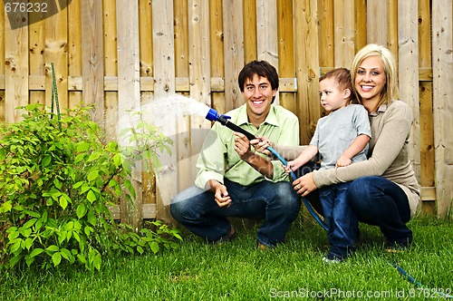 Image of Family watering plant