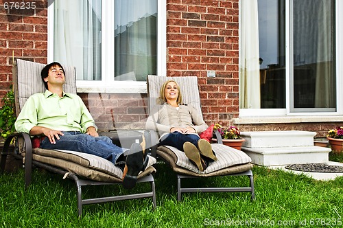 Image of Happy couple relaxing at home