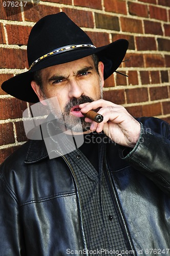 Image of Bearded man smoking cigar