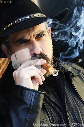 Image of Bearded man smoking cigar