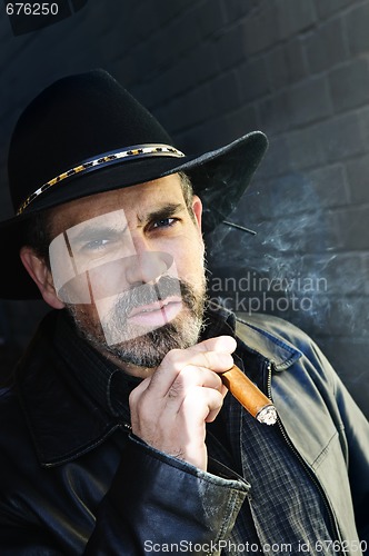 Image of Bearded man smoking cigar