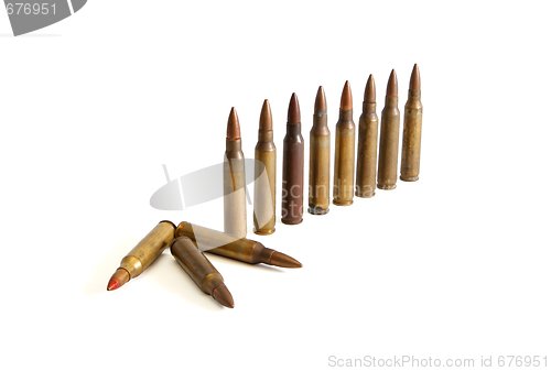 Image of Row of standing  M16 cartridges with some fallen isolated