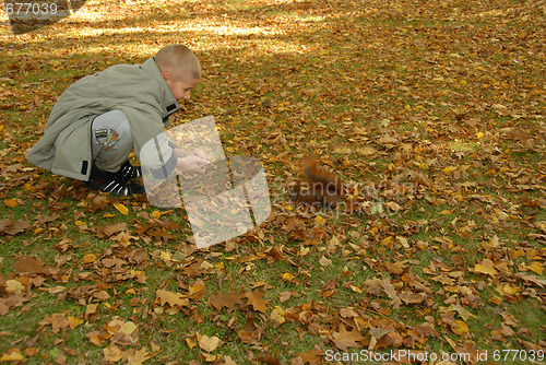 Image of teen boy and red squirrel