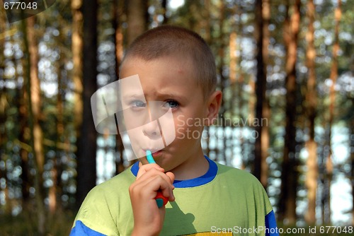 Image of boy is brushing his teeth