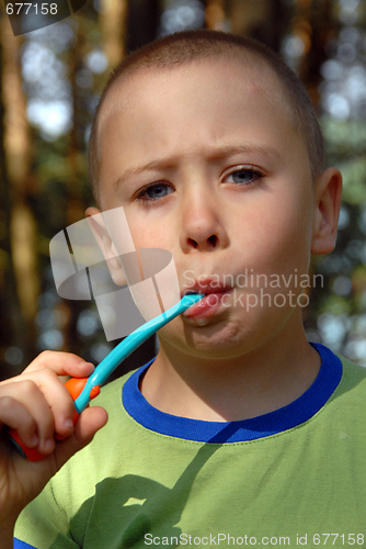 Image of boy is brushing his teeth