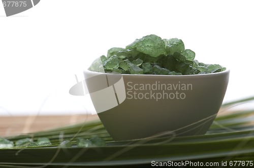 Image of bath salt and palm leaf