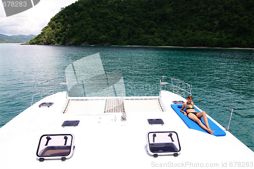 Image of Woman aboard yacht.