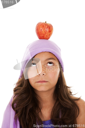 Image of young child with an apple on her head