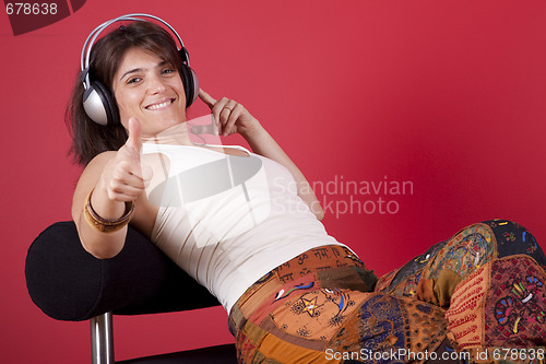 Image of Woman listen music at her house