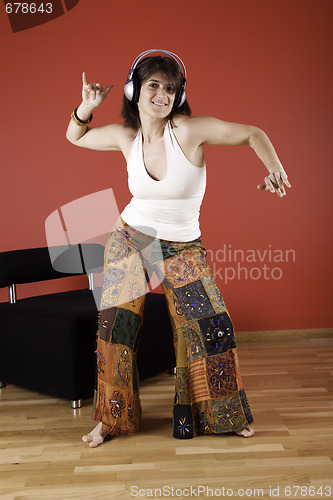 Image of Woman listen music at her house