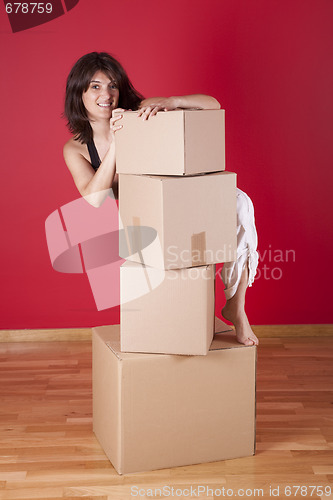 Image of Woman holding cardboard boxes