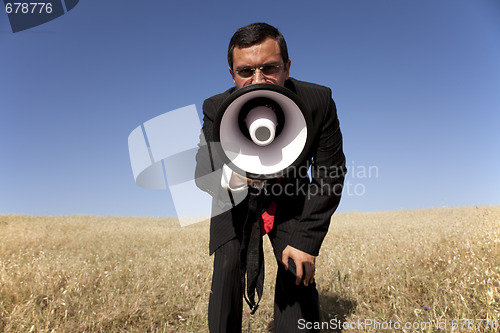Image of Businessman shouting at the megaphone to you