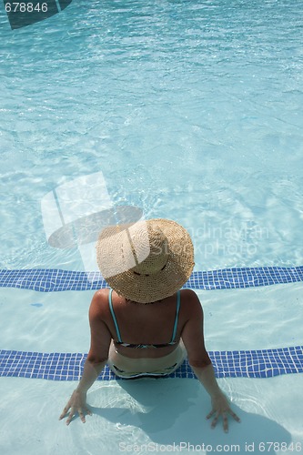 Image of woman relaxing at the pool