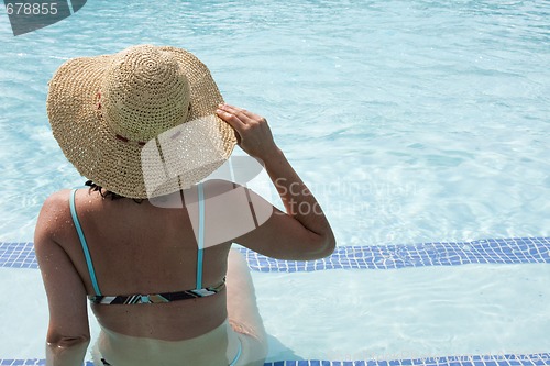 Image of woman relaxing at the pool