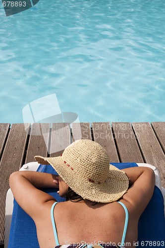 Image of woman relaxing at the pool