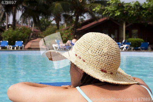 Image of woman relaxing at the pool