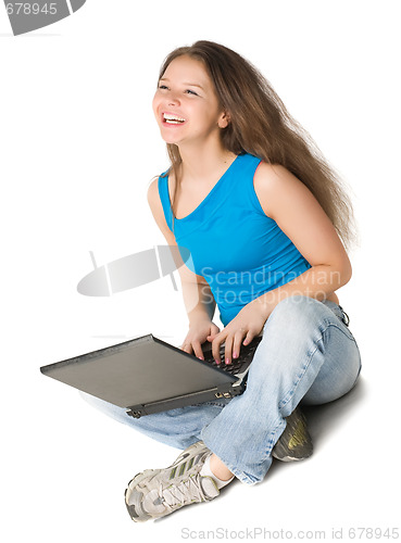 Image of girl with laptop sits on the floor