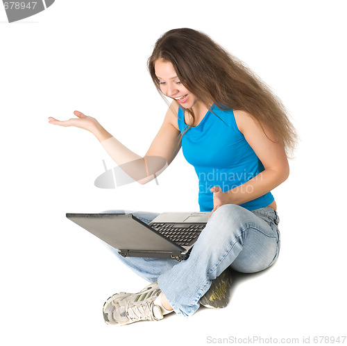 Image of girl with laptop sits on floor