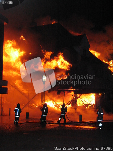 Image of Firefighters fighting burning house