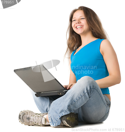 Image of girl with laptop sits on the floor