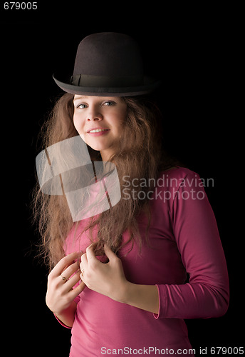 Image of Beautiful girl in a hat on a black background