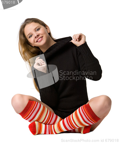 Image of smiling girl sits on the floor