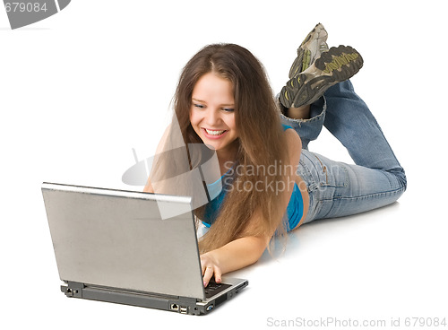 Image of girl with laptop lying on floor