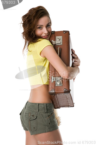 Image of girl hugs a suitcase with a smile