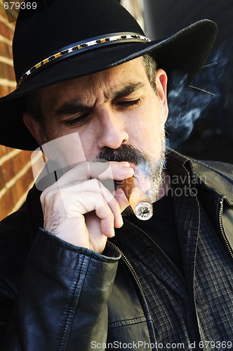 Image of Bearded man smoking cigar