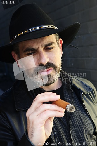 Image of Bearded man smoking cigar