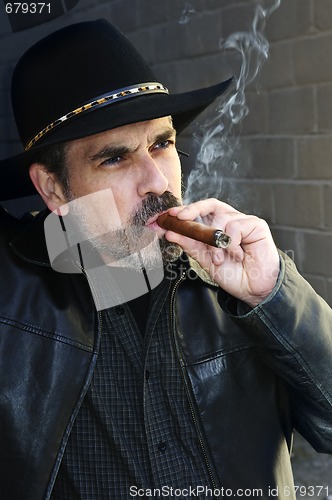 Image of Bearded man smoking cigar