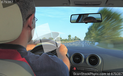 Image of Man driving a car