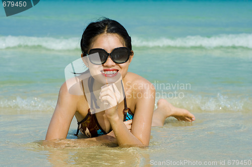 Image of beauty at the beach with hearts reflecting in her sunglasses