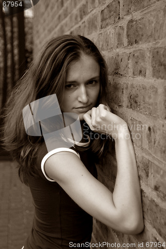 Image of girl near wall of brick