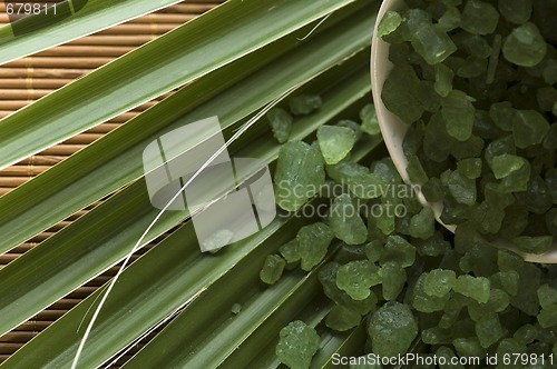 Image of bath salt and palm leaf