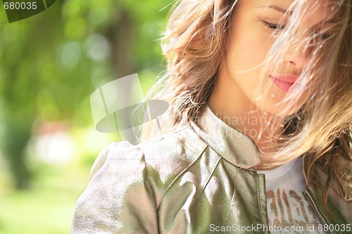 Image of beautiful smiling girl and wind