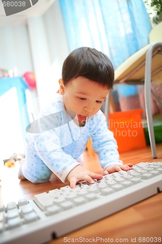 Image of little boy with keyboard, soft focus