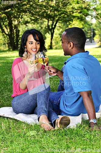Image of Happy couple having wine in park