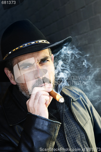 Image of Bearded man smoking cigar