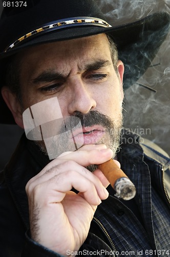 Image of Bearded man smoking cigar