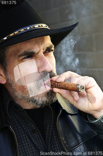 Image of Bearded man smoking cigar