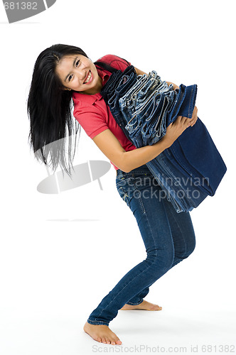 Image of young woman with her jeans collection