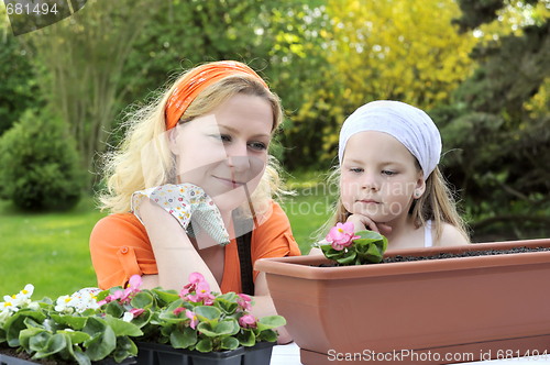 Image of Mother and daughter having gardening time