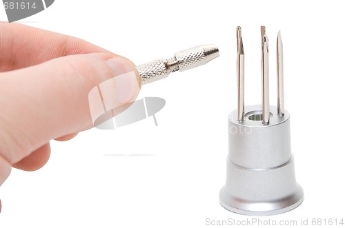 Image of Hand with metallic screwdriver