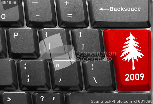 Image of computer keyboard with red Christmas tree key